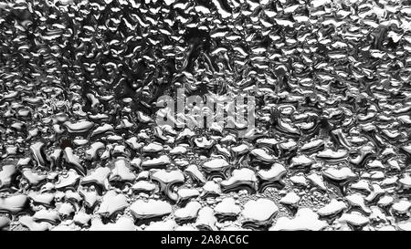Raindrops collecting on a window to create a mosaic. Stock Photo