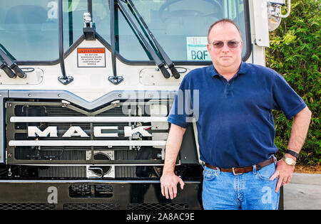 Tim Dolan, Waste Pro Regional Vice President for Central Florida, poses with a Mack truck at Waste Pro, March 18, 2016, in Sanford, Florida. Stock Photo