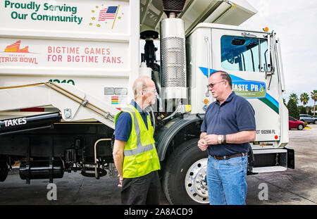 Waste Pro operations specialist Terry Grady talks to Tim Dolan, Waste Pro regional vice president for Central Florida, at Waste Pro in Sanford. Stock Photo