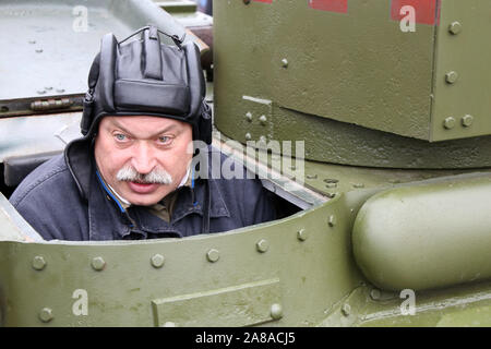 Russian tankman in military uniform sitting in the hatch of heavy tank during a historic parade on Red square Stock Photo