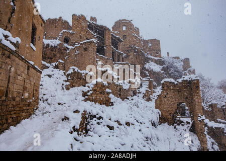 Old antique abandoned city Gamsutl in foggy snowy winter Caucasus mountains, Dagestan, Russia. Stock Photo