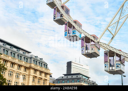 Ferris wheel cabins and downtown architecture of Brussels skywards, Belgium Stock Photo
