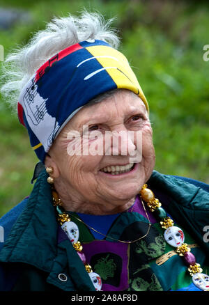 An elderly woman smiles as she watches the annual Mardi Gras parade March 6, 2011 in Grand Isle, Louisiana. Stock Photo