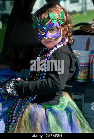 A little girl watches the annual Mardi Gras parade March 6, 2011 in Grand Isle, Louisiana. Stock Photo