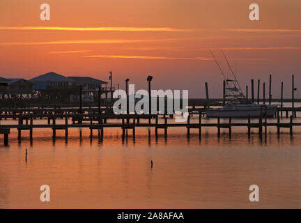 The sun sets on Grand Isle, a barrier island situated on the Gulf of Mexico at the southernmost tip of Louisiana, Nov. 23, 2010. Stock Photo