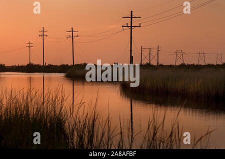 The sun sets on Grand Isle, a barrier island situated on the Gulf of Mexico at the southernmost tip of Louisiana, Nov. 23, 2010. Stock Photo