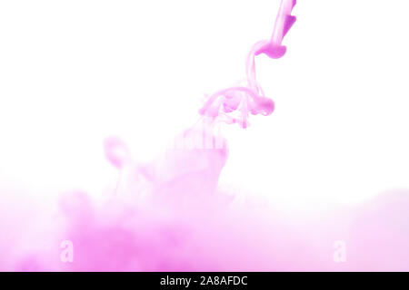 Abstract flowing liquid or purple ink in water on a white background. Stock Photo