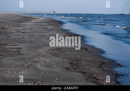 Waves crash on the beach at Grand Isle State Park on March 6, 2011 in Grand Isle, Louisiana. The island was heavily impacted by the BP oil spill. Stock Photo