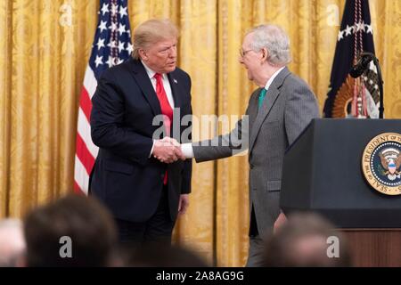 U.S. President Donald Trump thanks Senate Majority Leader Mitch McConnell during an event celebrating the federal judicial confirmation milestones in the East Room of the White House November 6, 2019 in Washington, DC. Stock Photo