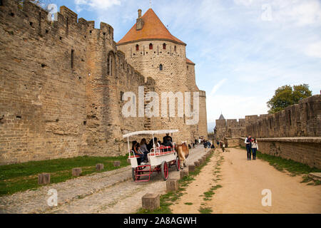 People visitors tourists at the hill top medieval castle Citadel in the fortified French city  town of Carcassonne  in the Languedoc region of France Stock Photo