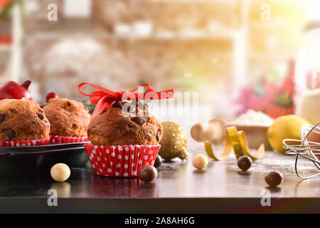Christmas table with freshly baked muffins with traditional cuisine in the background. Horizontal composition. Front view. Stock Photo