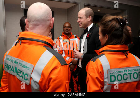 The Duke of Cambridge speaks with (left to right) Paramedic Steve Jones, Anaesthetic Consultant at Guys and St Thomas Hospitals Doctor John Chatterjee and Royal London Hospital Consultant in emergency medicine Doctor Flora Bird as he attends the London's Air Ambulance Charity gala at Rosewood London in Holborn. Stock Photo