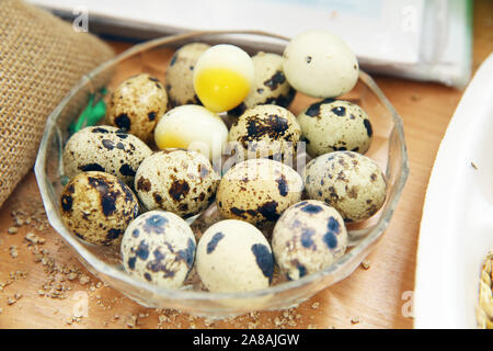 Quail Eggs In A Glass Bowl Top View . quail eggs in a glass bowl . The quail eggs are in the white glass plate. Stock Photo