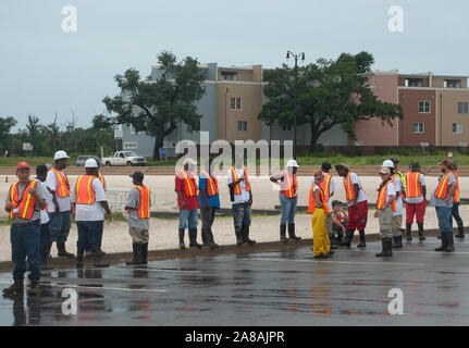 Oil spill cleanup workers await instruction on the beach in Gulfport, Mississippi after the BP oil spill, June 30, 2010. Stock Photo