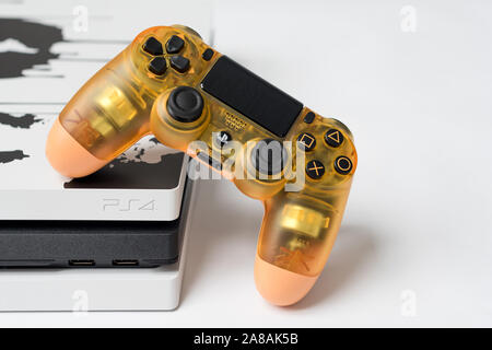 KIEV, UKRAINE - November 07, 2019: Death Stranding Limited Edition PS4 Pro. Sony PlayStation 4 game console and transparent controller on white Stock Photo