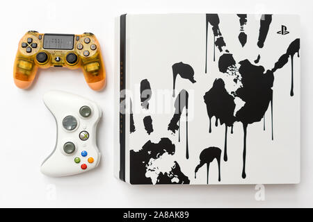 KIEV, UKRAINE - November 07, 2019: Death Stranding Limited Edition PS4 Pro.Sony PlayStation 4 game console and controllers dualshock gamepads on white Stock Photo