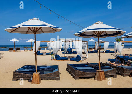Luxury sun loungers or canopy beach beds and parasols on the beach of Nusa Dua, Bali, Indonesia, Southeast Asia, Asia Stock Photo