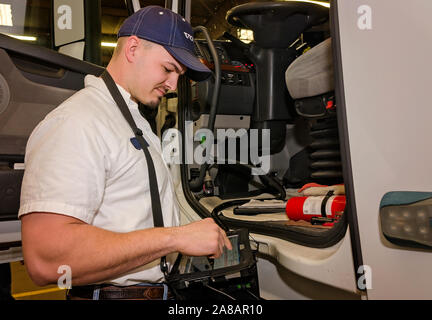 A Volvo service manager checks diagnostics on a customer’s Volvo, Nov. 15, 2017, at Bruckner Truck Sales in Farmington, New Mexico. Stock Photo