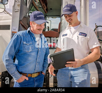A Mack Trucks service manager discusses a repair estimate with a customer, Nov. 15, 2017, at Bruckner Truck Sales in Farmington, New Mexico. Stock Photo
