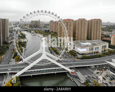 Aerial view cityscape of Tianjin ferris wheel. Famous Tianjin Eye ferris wheel above the Yongle Bridge and the Haihe river. Popular modern landmark in Tianjin, China. October, 28th, 2019 Stock Photo