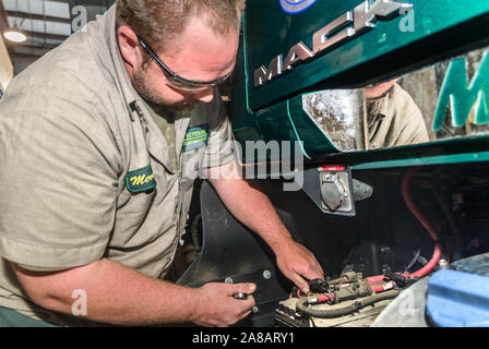 A technician performs routine maintenance on a Mack Pinnacle truck at Superior Transportation, Oct. 2, 2015, in North Charleston, South Carolina. Stock Photo