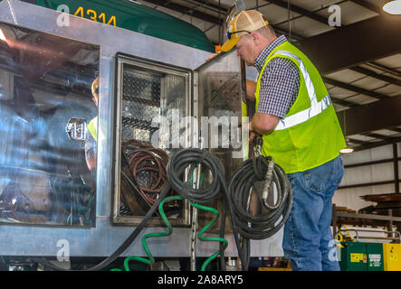 A technician performs routine maintenance on a Mack Pinnacle truck at Superior Transportation, Oct. 2, 2015, in North Charleston, South Carolina. Stock Photo