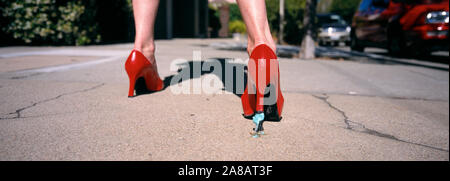 Bubble gum stuck to the heel of a woman's shoe Stock Photo