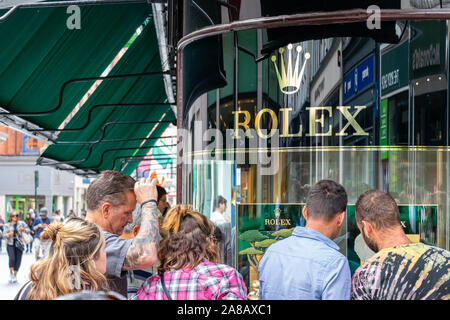 People looking watches at the Rolex store in the city center of Dublin