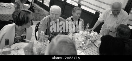 High angle view of two senior men and two senior women at a dining table, Italy Stock Photo