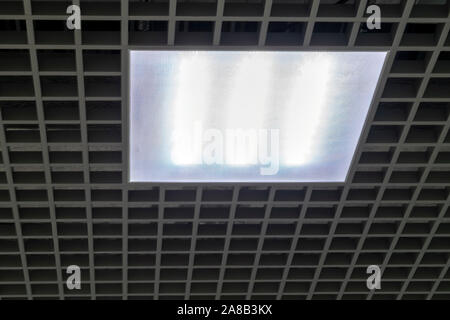 Fragment of the ceiling with LED ceiling lamp close-up. Modern square lamp in the ceiling close up. Stock Photo