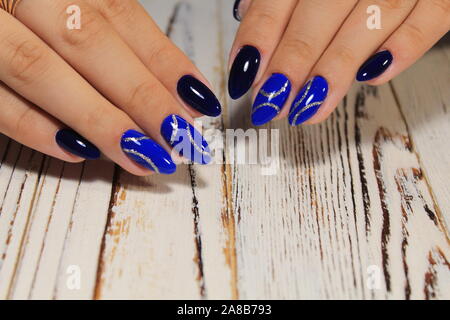 fashionable blue manicure of nails on a beautiful textural background Stock Photo