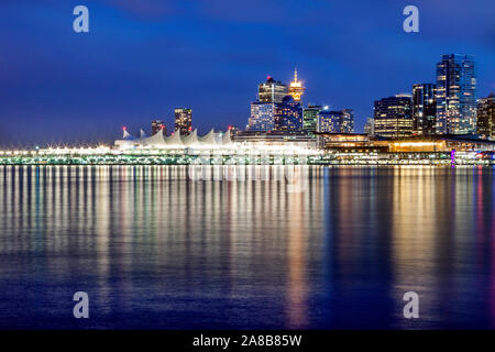Long exposure after sunset view on downtown Vancouver and Convention Center over Coal Harbour, reflections. Vancouver, British Columbia, Canada Stock Photo