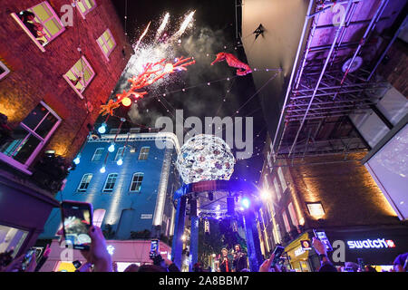The crowds packed Carnaby street to see Ronnie Wood turn the lights on. The theme this year is Save the Planet by Project Zero. They are an ocean conservation charity and they created an eco friendly display. All the decorations are made out of recycled material. Stock Photo