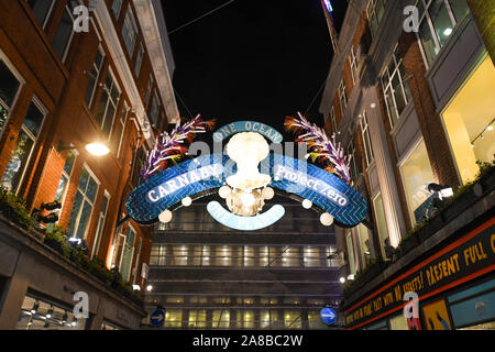 The crowds packed Carnaby street to see Ronnie Wood turn the lights on. The theme this year is Save the Planet by Project Zero. They are an ocean conservation charity and they created an eco friendly display. All the decorations are made out of recycled material. Stock Photo