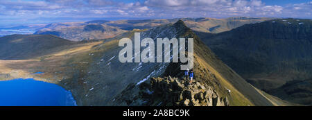 Hikers hiking on a mountain, Striding Edge, Helvellyn, English Lake District, Cumbria, England Stock Photo