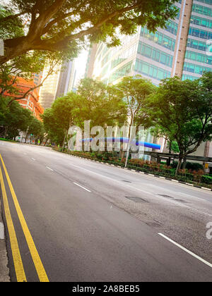 Empty asphalt road in city. Green city with skyscraper modern office building. Business and financial center glass building. Cityscape. Green tree Stock Photo