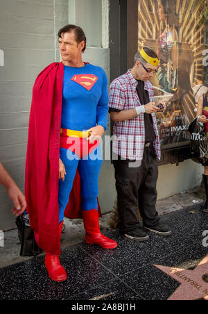 Christopher Dennis, the 'Hollywood Boulevard Superman,' on the Walk of Fame in Los Angeles, California. Dennis died on November 2nd, 2019. (Other person unidentified.) Stock Photo