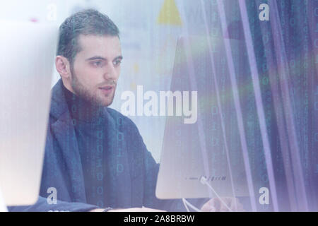 Young male Businessman working on modern computer. Businessman using innovative technologies. Businessman working on computer, software developing wit Stock Photo