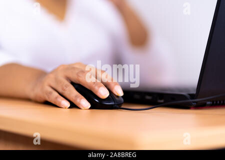 Female hand holding computer mouse Stock Photo