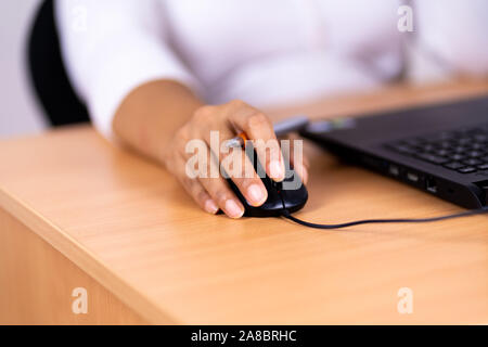 Female hand holding computer mouse Stock Photo