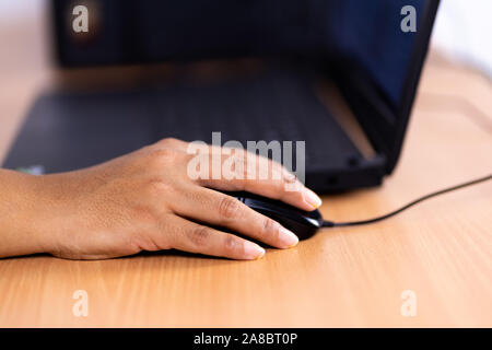 Female hand holding computer mouse Stock Photo