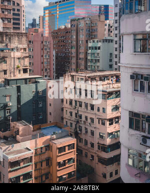 Tightly packed apartment buildings in Mong Kok. The area is one of the most overcrowded parts of Hong Kong. Apartments, office buildings and malls. Stock Photo