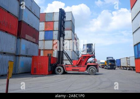 Container handlers are loading containers into trucks Stock Photo - Alamy