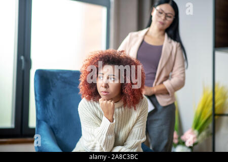 Woman feeling thoughtful while listening to psychoanalyst Stock Photo