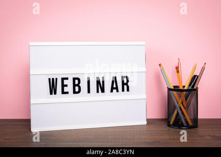 Webinar. E-learning, training, business and internet technology concept. White lightbox on a wooden table Stock Photo
