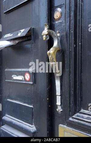 An ornate vintage brass door handle in the form of a Griffin. Brussels, Belgium Stock Photo