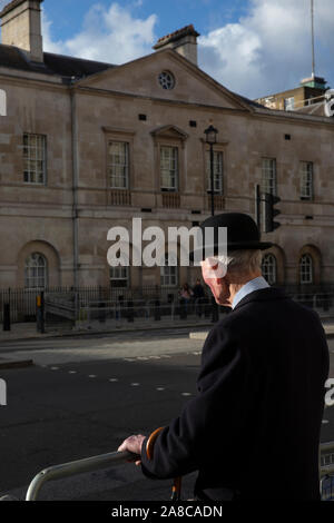 Former army veteran, civil servant, gentleman wearing a bowler hat, taking a stroll down Whitehall, London, England, United Kingdom Stock Photo