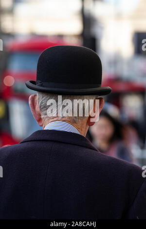 Former army veteran, civil servant, gentleman wearing a bowler hat, taking a stroll down Whitehall, London, England, United Kingdom Stock Photo