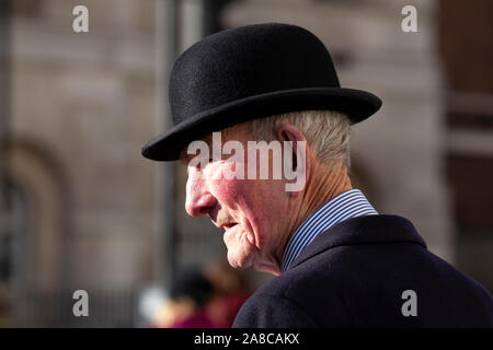 Former army veteran, civil servant, gentleman wearing a bowler hat, taking a stroll down Whitehall, London, England, United Kingdom Stock Photo