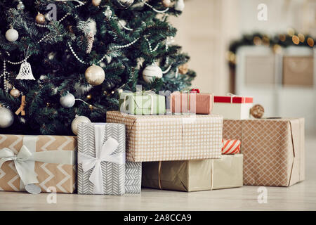 Close-up of Christmas presents in wrapping paper are on the floor under the Christmas tree Stock Photo